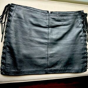 bebe Black Leather Lace-Up Mini Skirt with satin lining and back zipper.